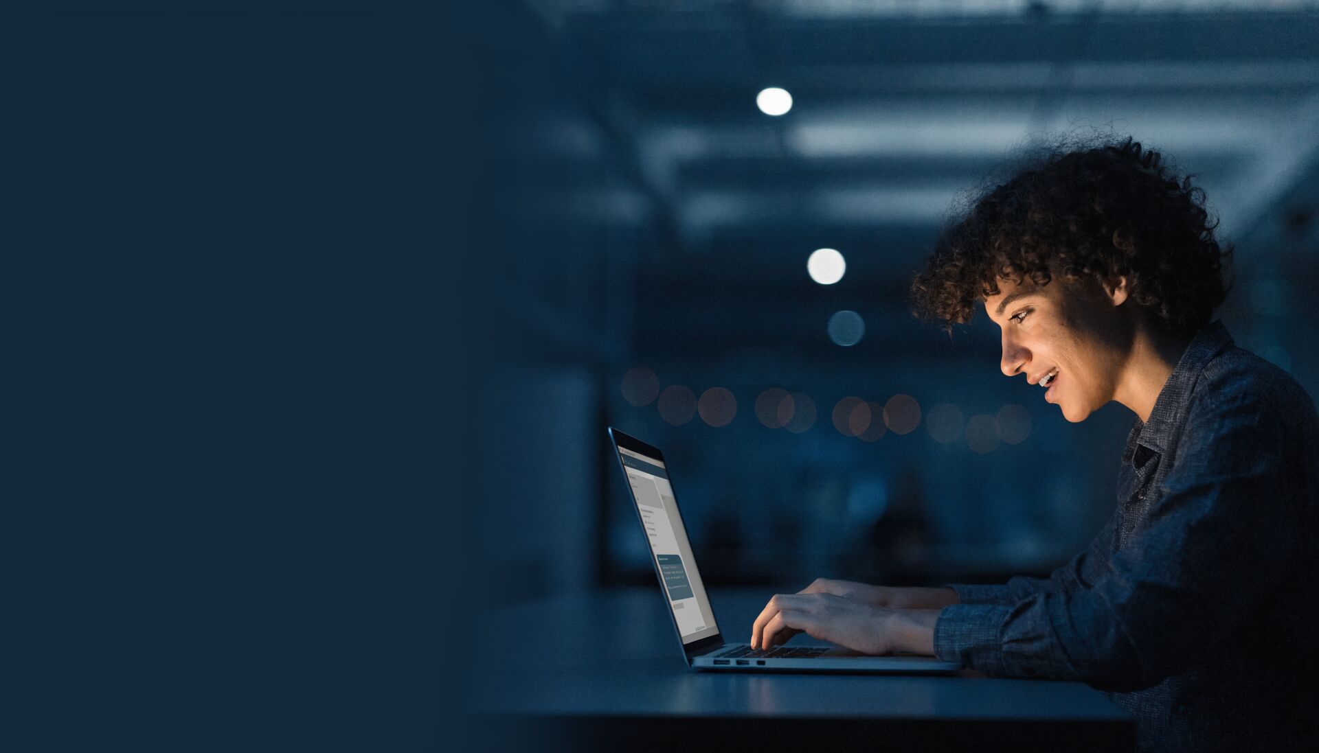 A support specialist writing chat replies on a laptop