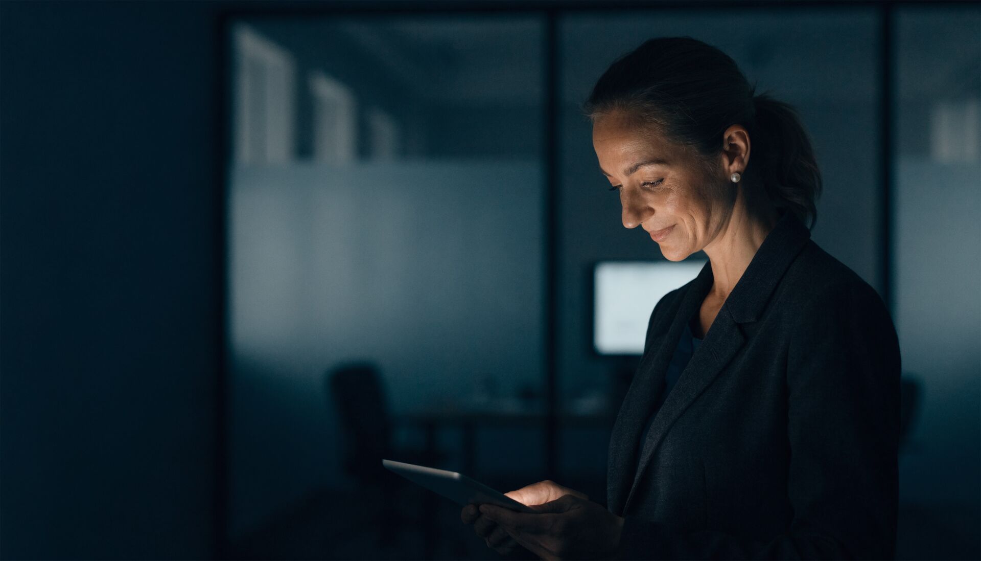 A compliance manager reviewing records on a tablet